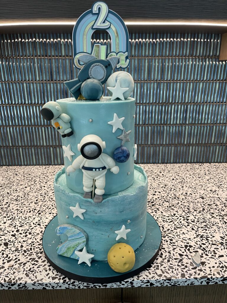 Astronaut cake with rocket starts and cake topper