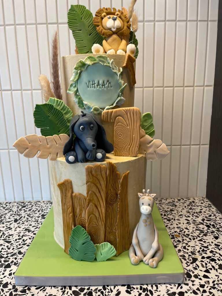 Jungle cake with fondant giraffe, fondant lion and fondant elephant