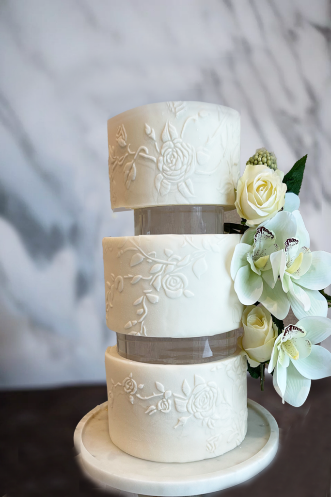 3-tiered wedding cake with orchids and glass spacers